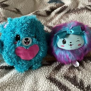 Two pom pom stuffed animals